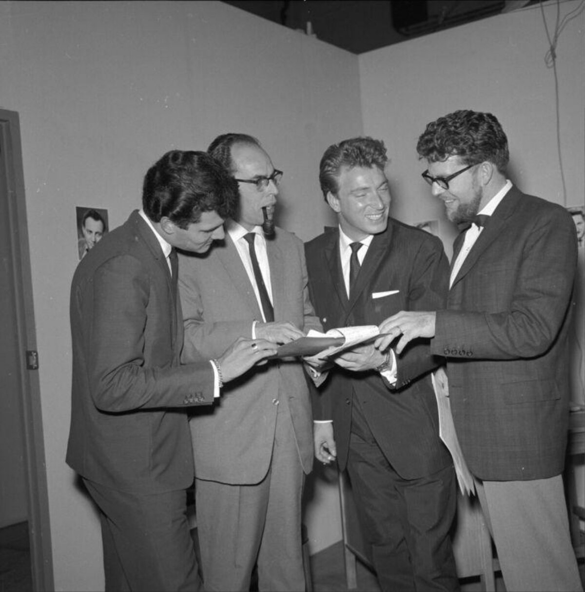 Four Men Discussing a Shared Document