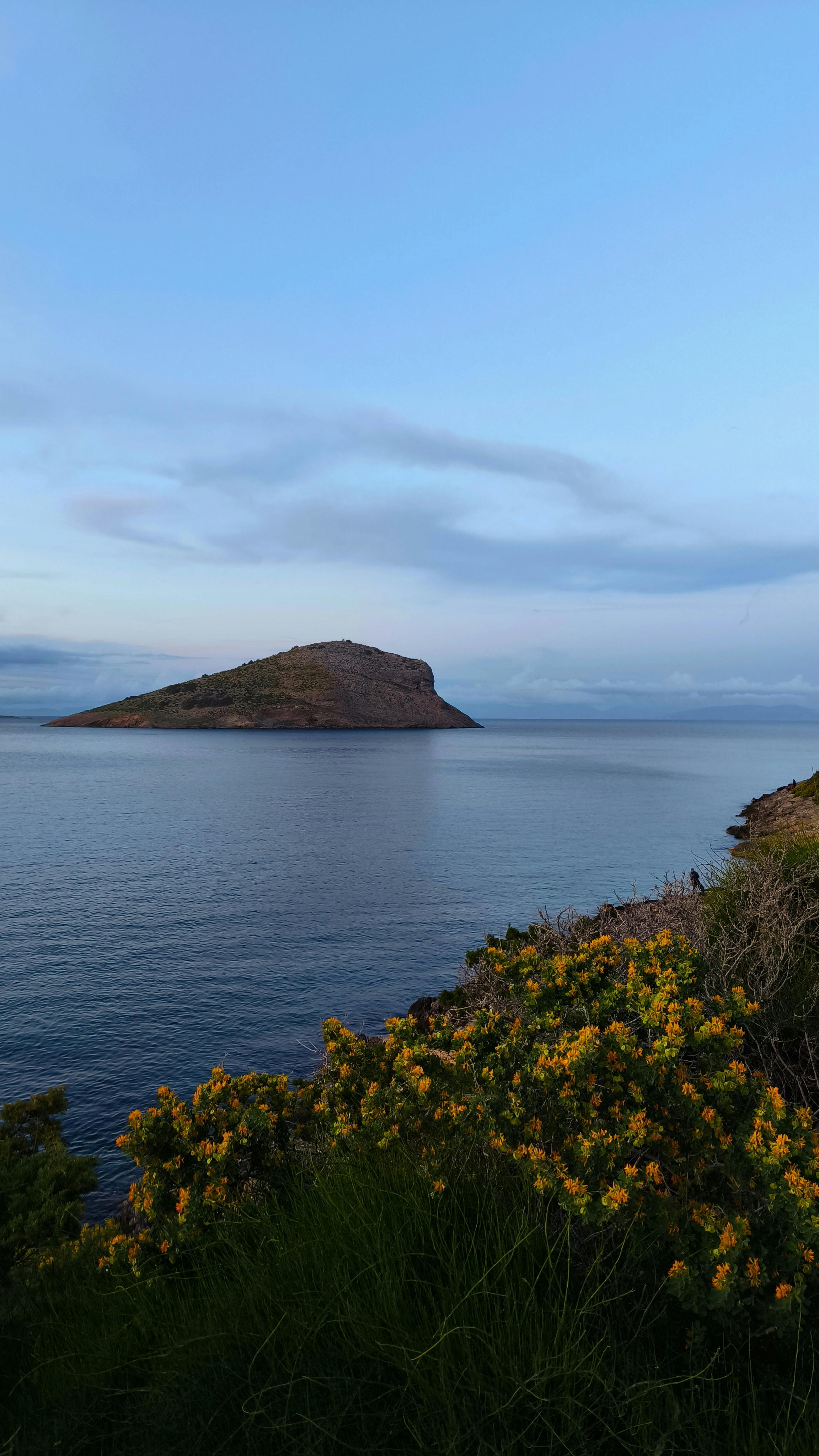 Rocky Island in Calm Coastal Sea