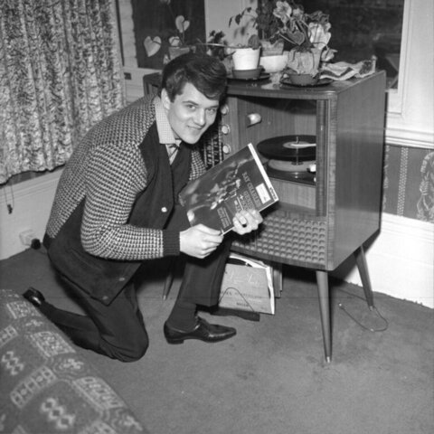 Man Poses With Ray Charles Vinyl Record