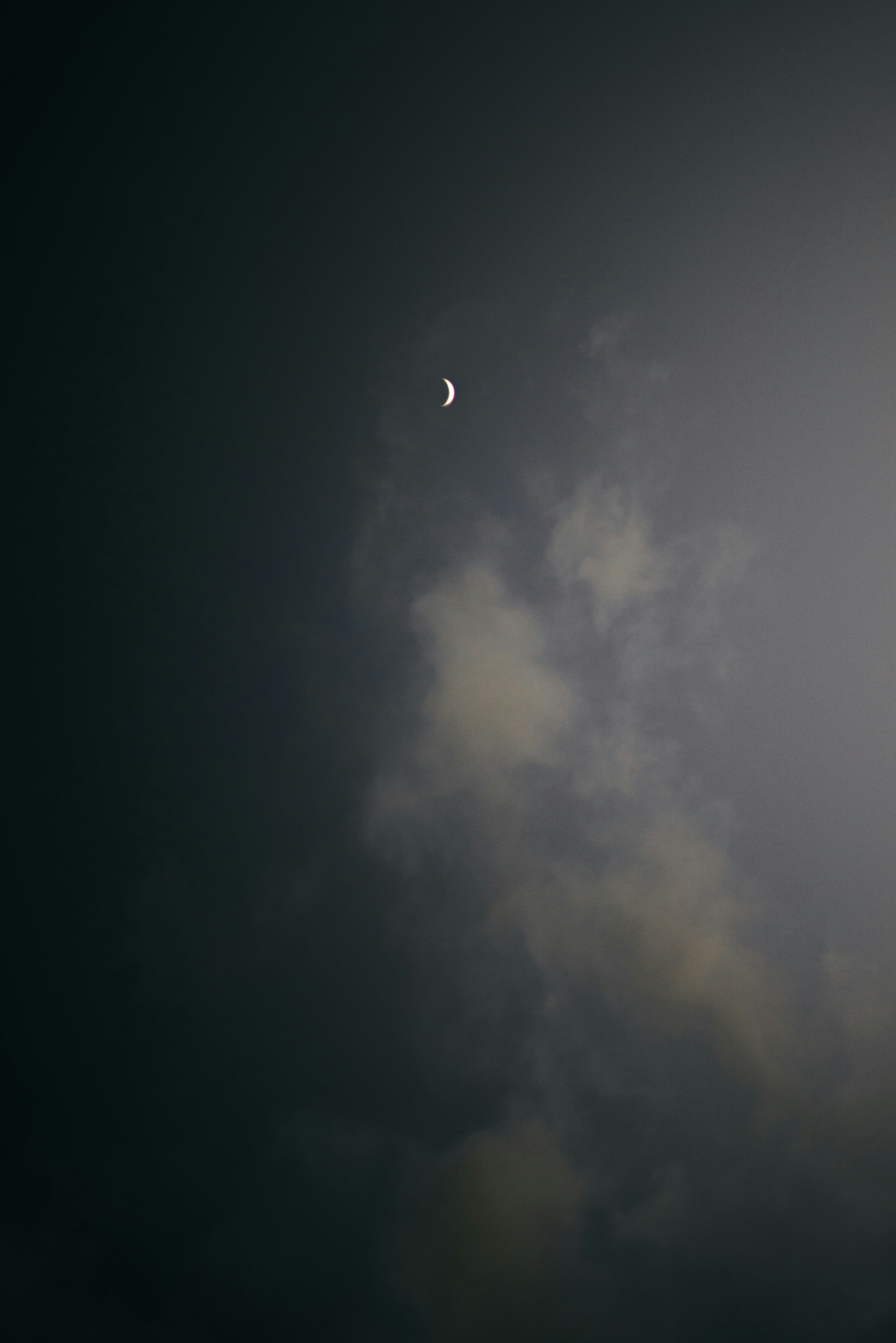 Crescent Moon Over Cloudy Night Sky