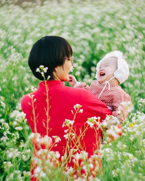 Mother and Baby in White Flower Field