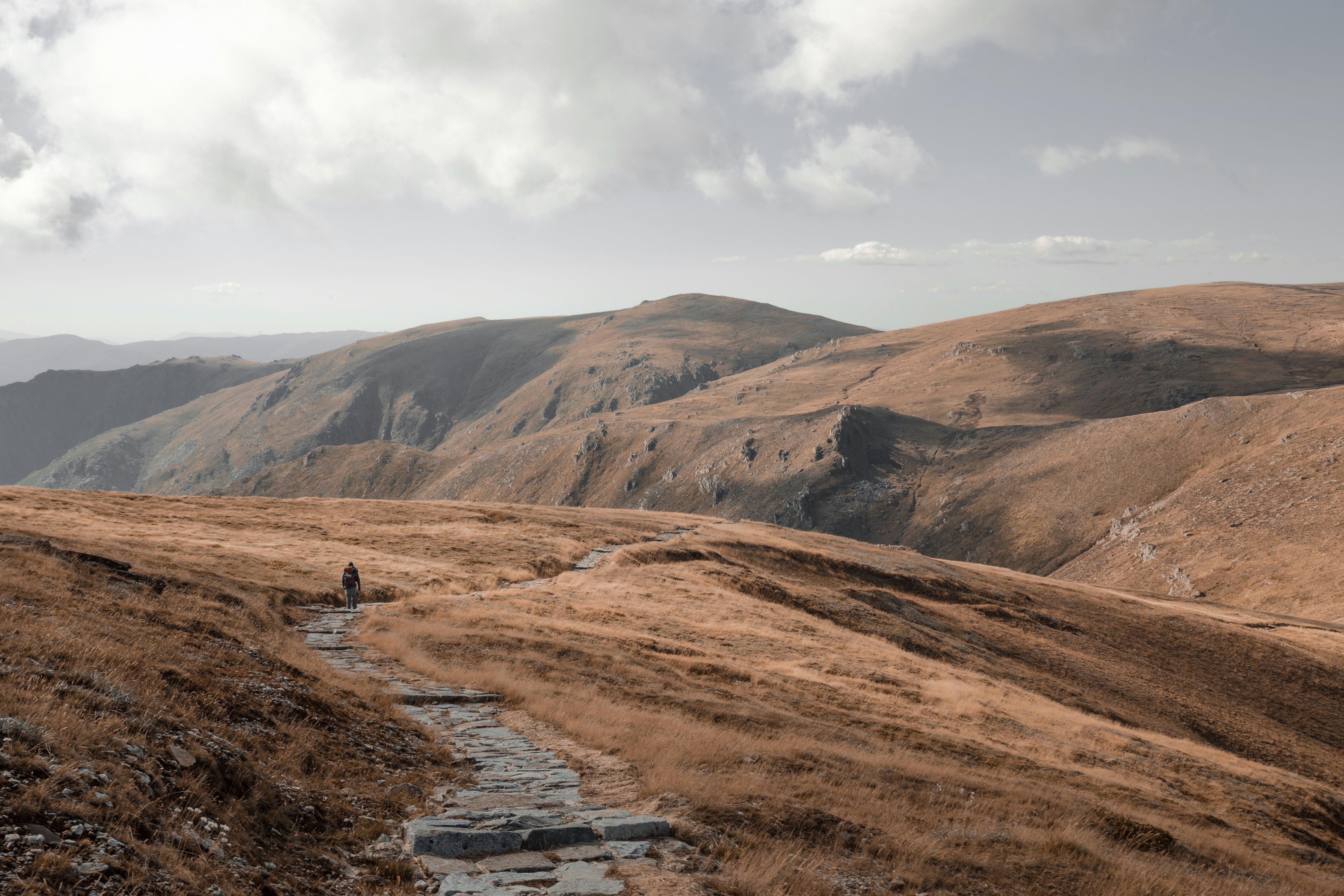 Hiker Walking on Mountain Path