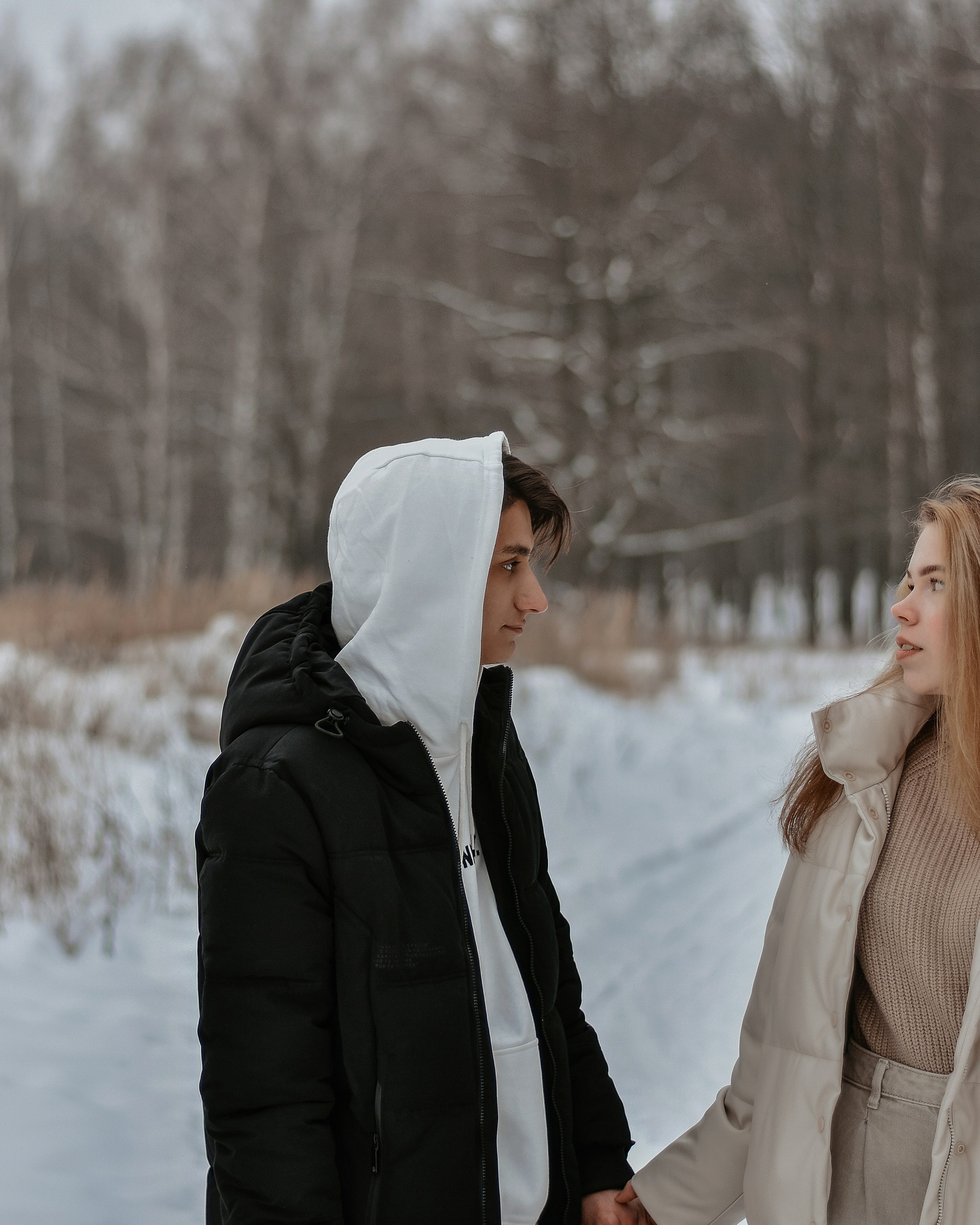 Couple Holding Hands in Winter Forest