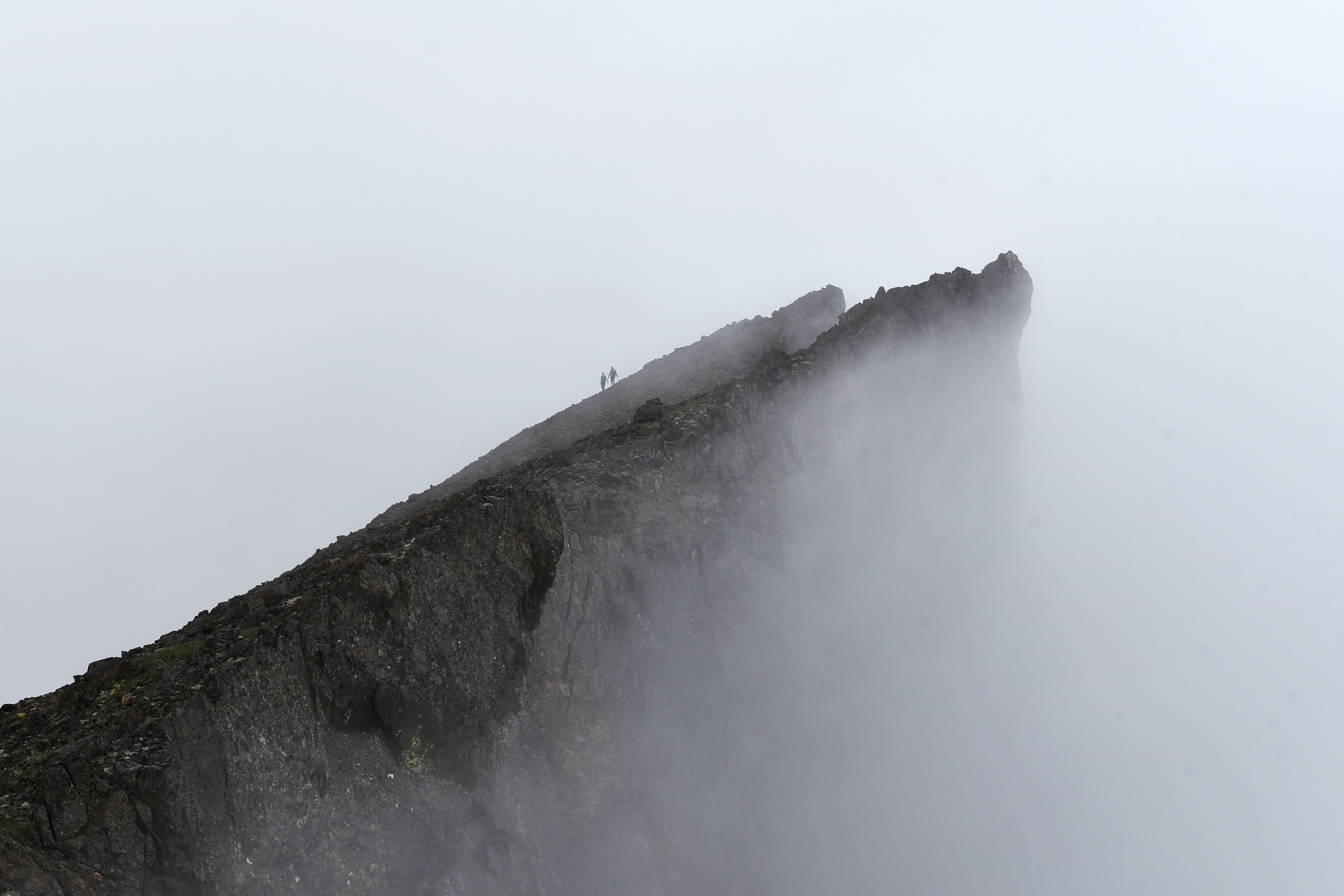 Hikers on Foggy Mountain Ridge