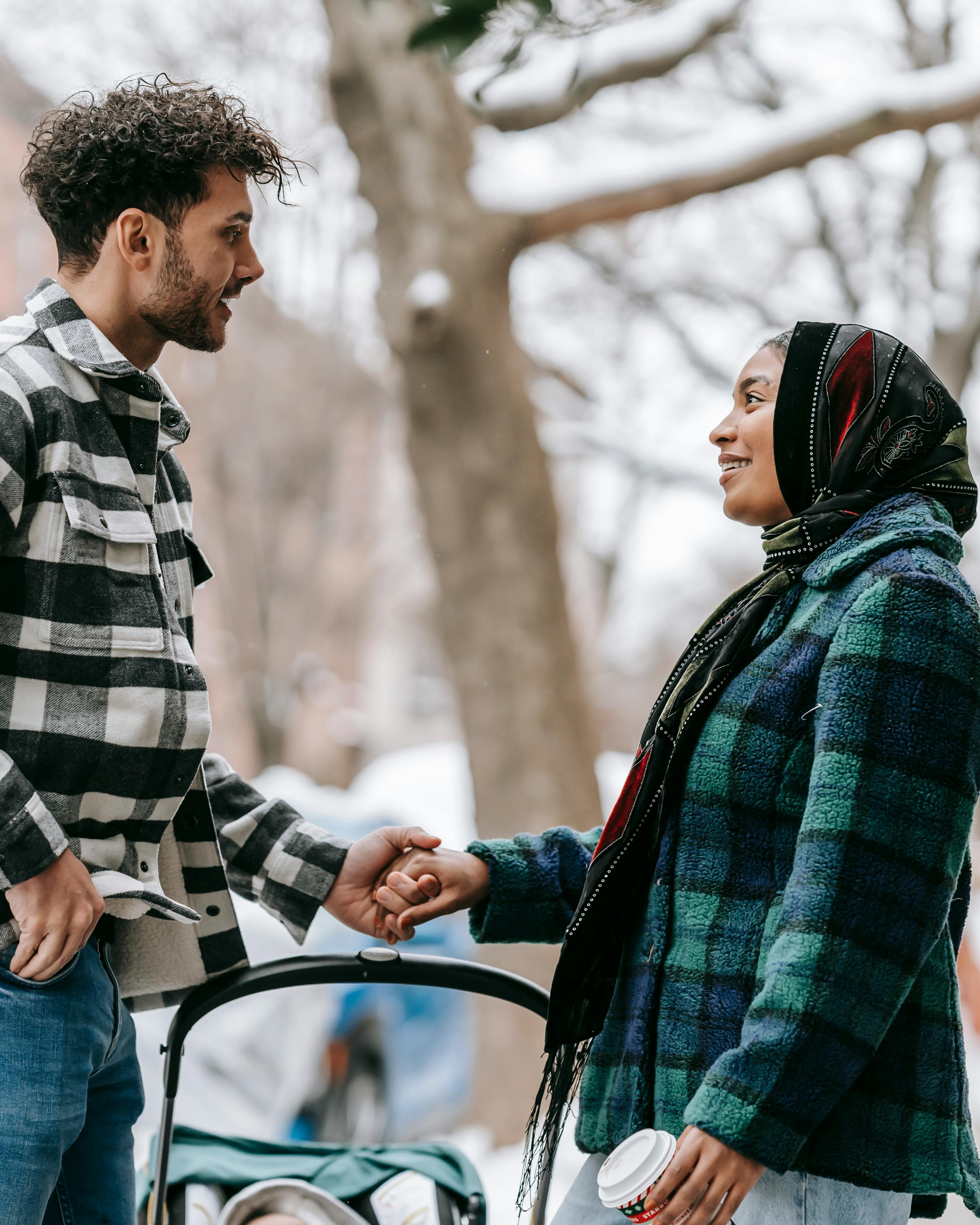 Two People Shaking Hands In Winter