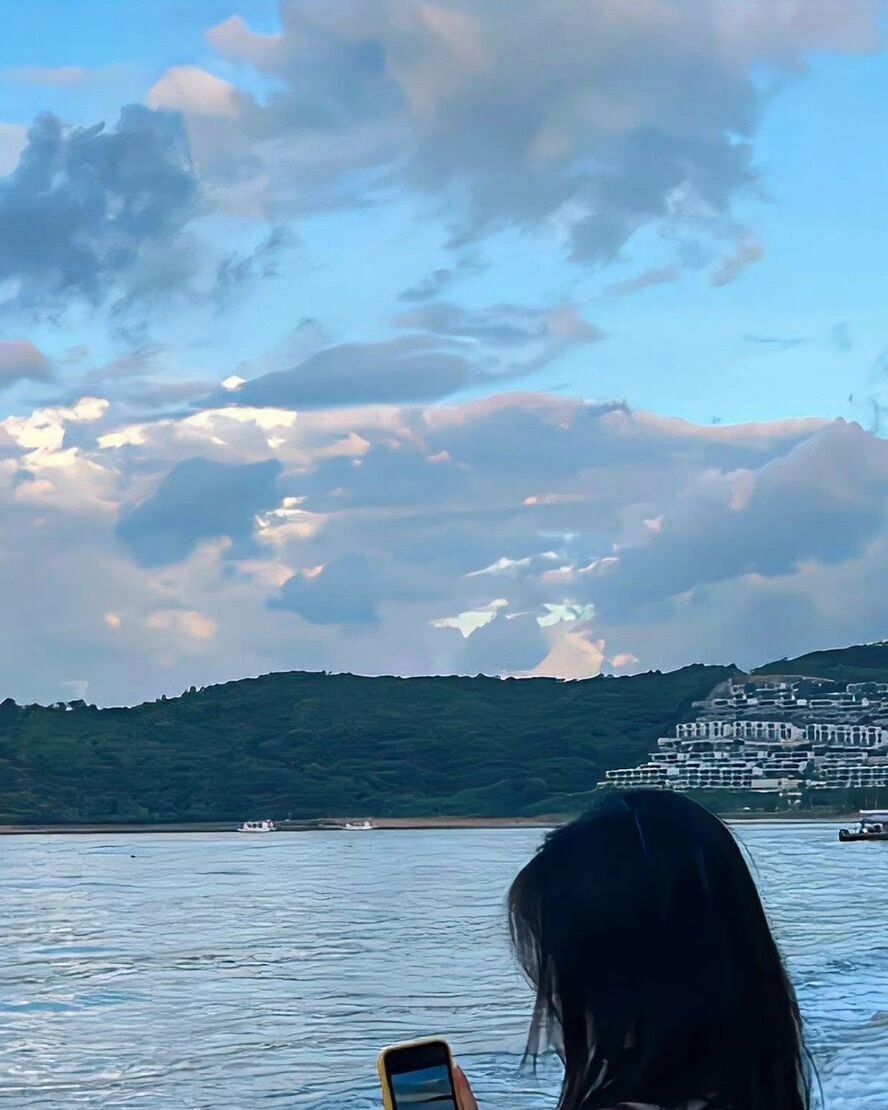 Woman Viewing Waterfront Landscape