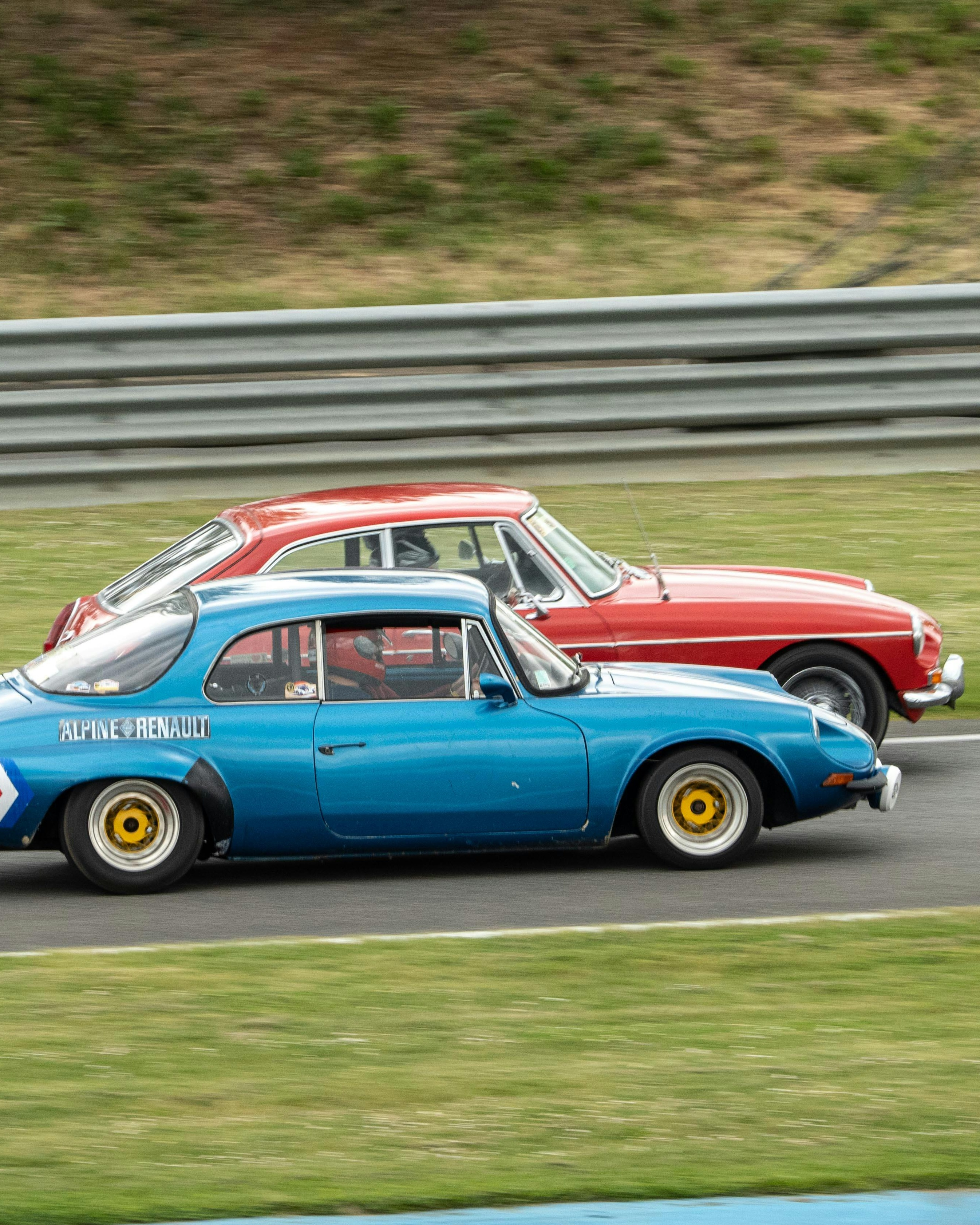 Two Vintage Race Cars Racing on Track