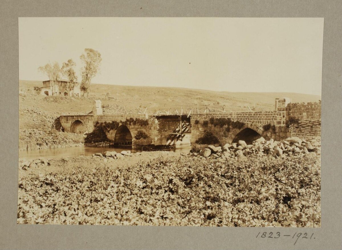 Damaged Stone Arch Bridge Over River