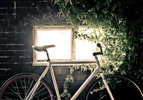 White Bicycle Against Brick Wall