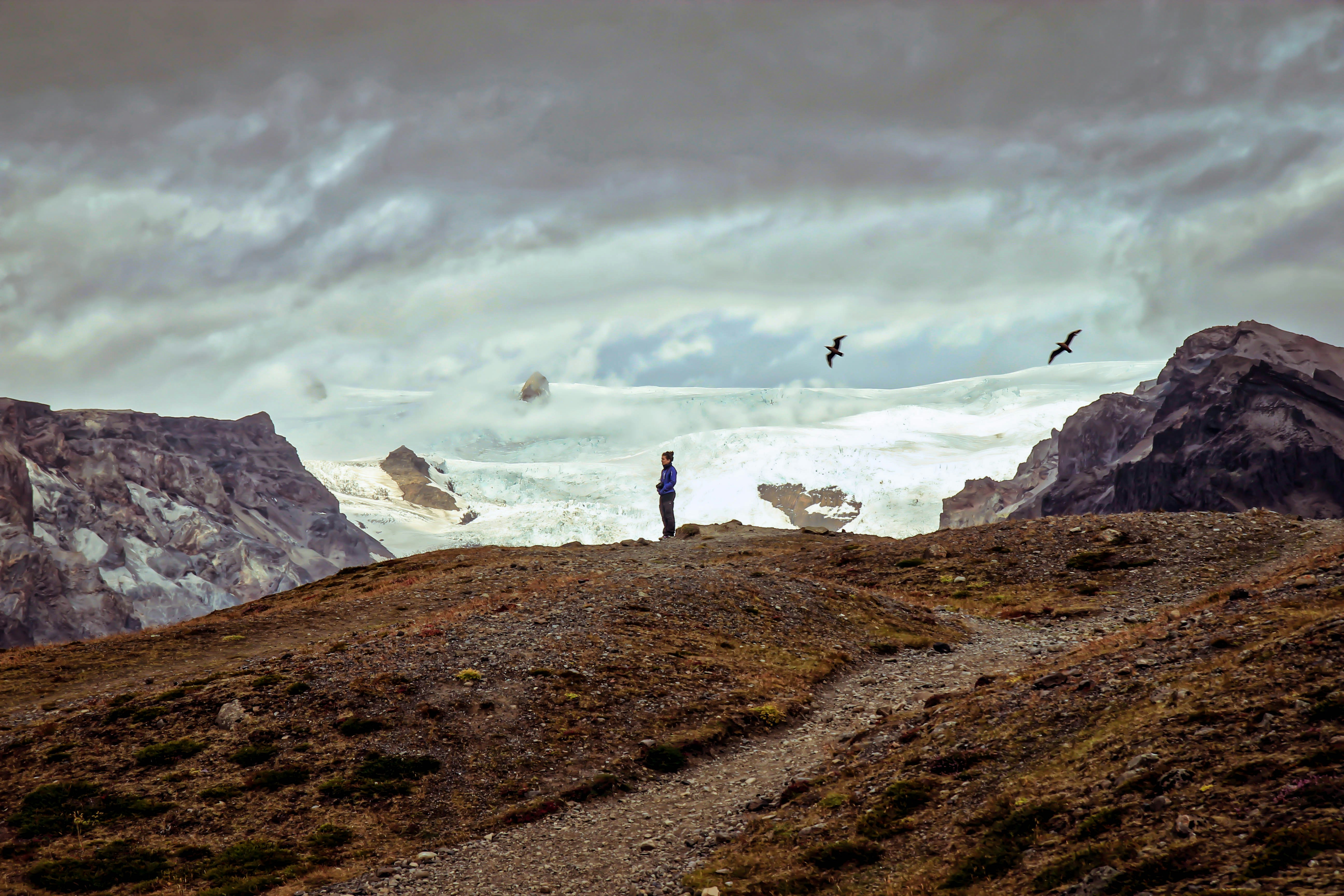 Hiker Overlooking Mountain Glacier